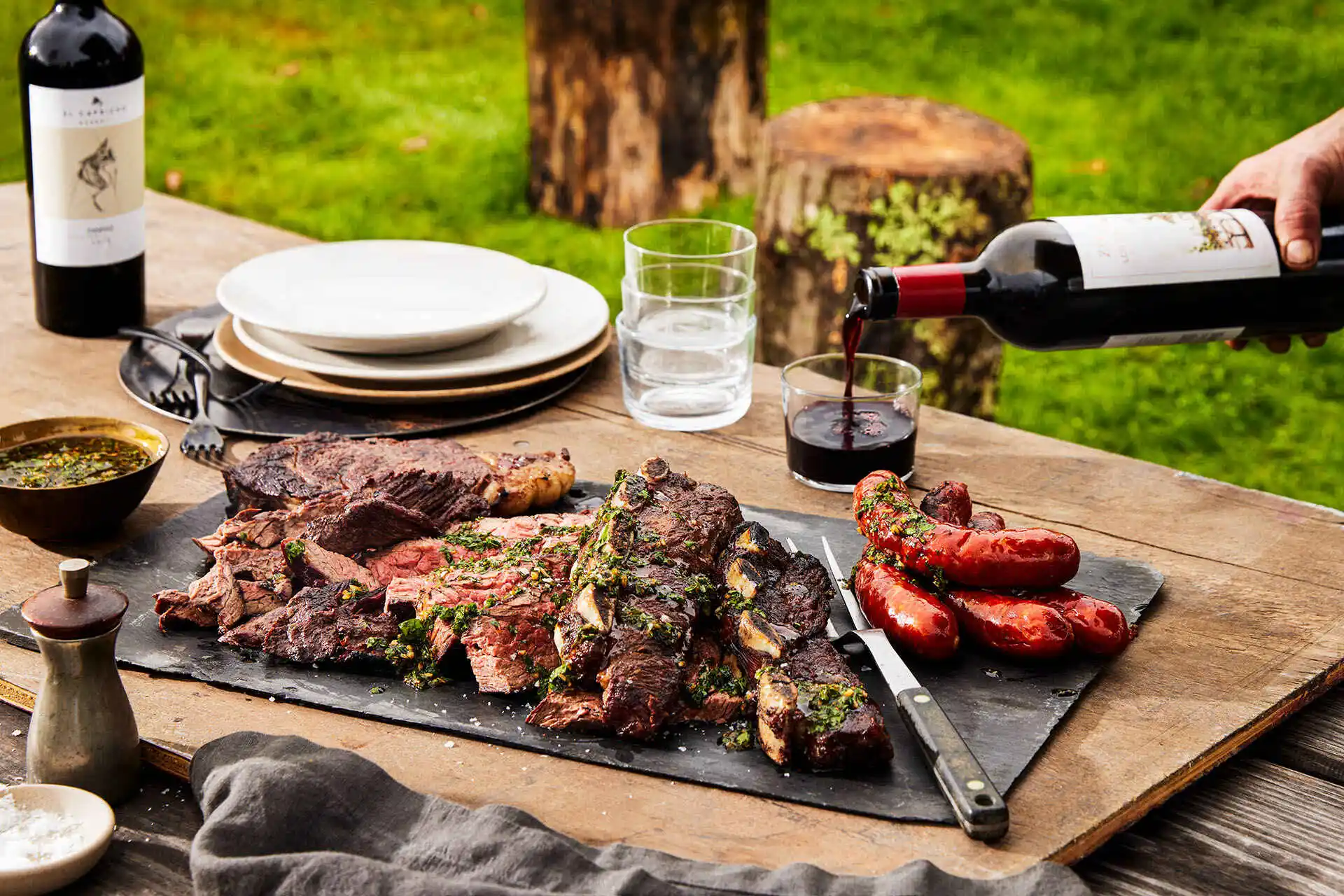 The group sharing steaks and Malbec at a long table in the evening